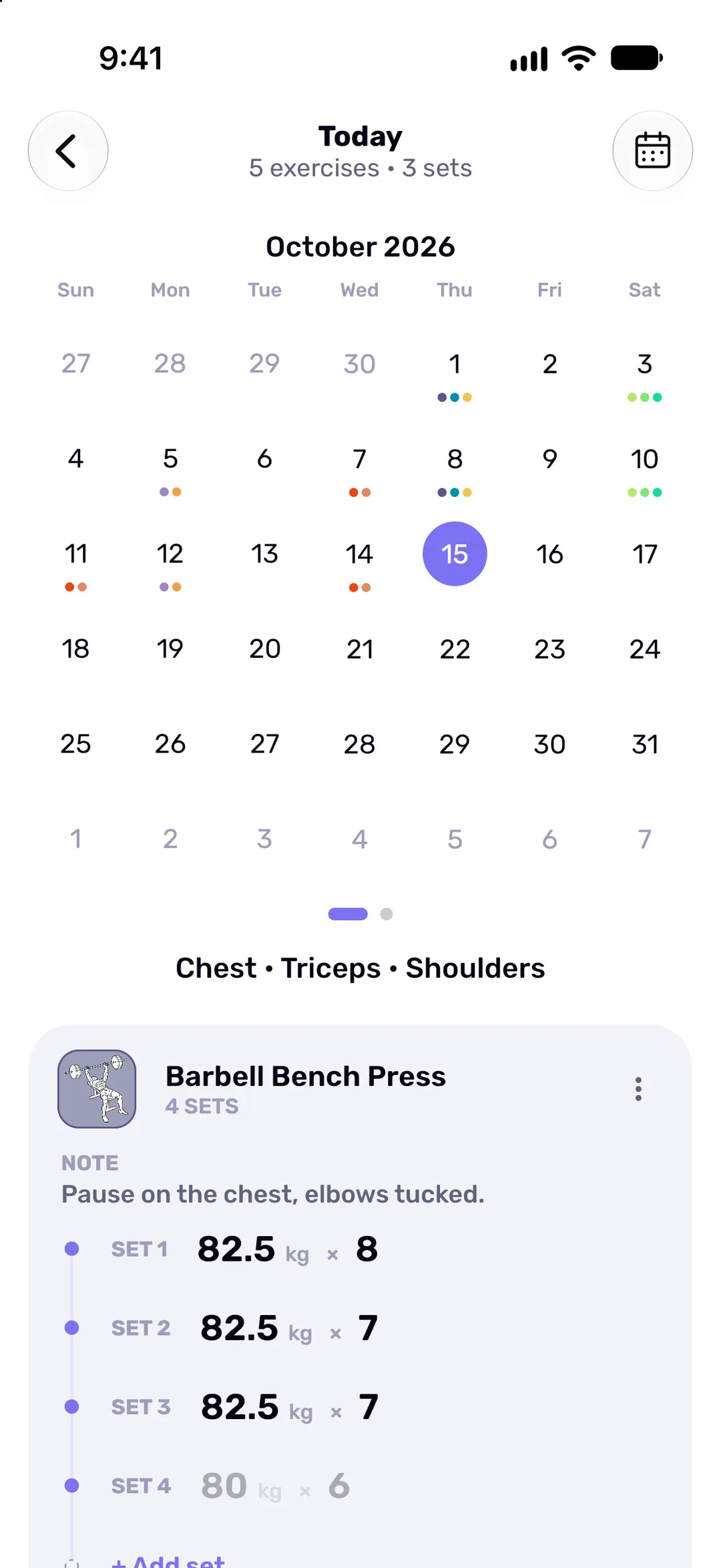 A monthly calendar in which every training day carries coloured dots for the muscle groups trained.